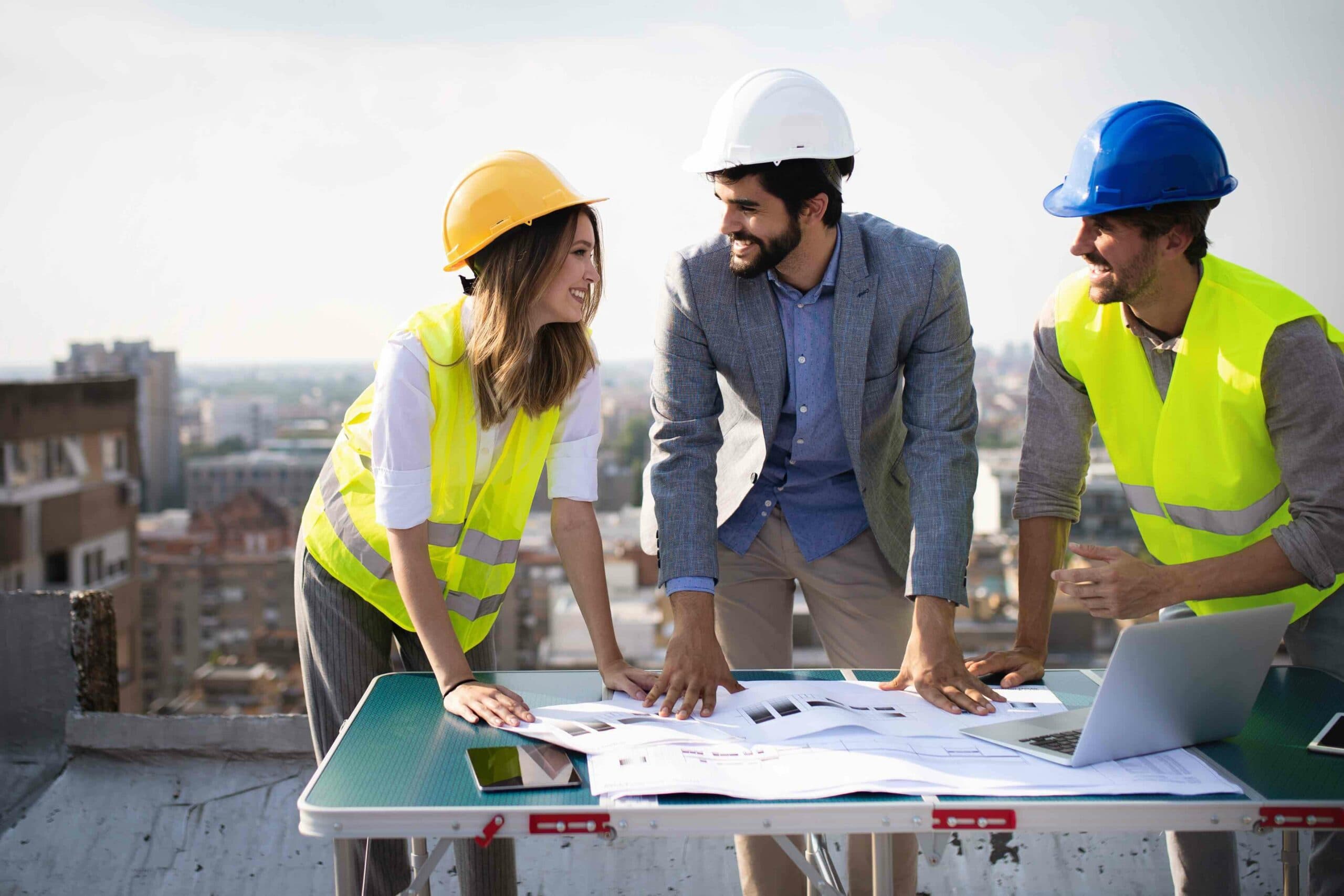 Safety consultants reviewing project plans on a rooftop